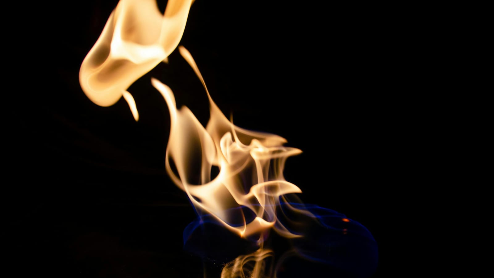 Artistic capture of dancing flames against a dark background, creating a dramatic effect.